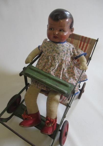 A painted metal dolls pushchair Image
