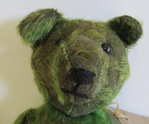 A pre-war green jointed teddy Image