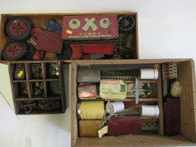 Red and green playworn Meccano parts including strips Image