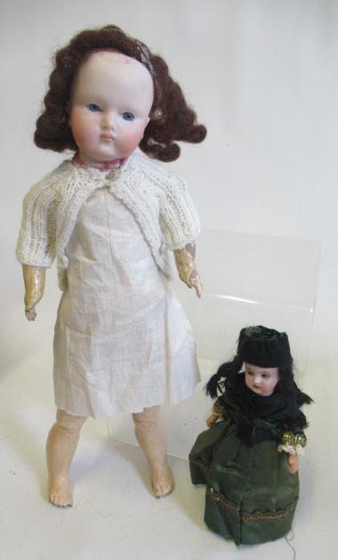 Two bisque socket head dolls comprising a 7 1/2" doll with blue glass sleeping eyes Image