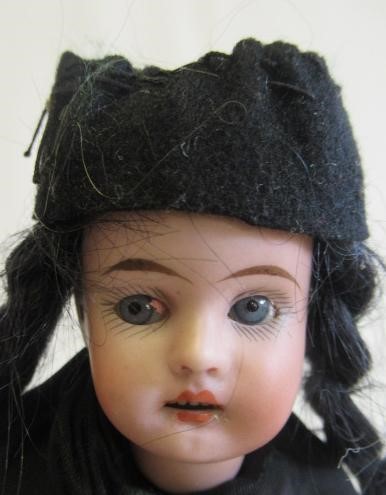 Two bisque socket head dolls comprising a 7 1/2" doll with blue glass sleeping eyes Image