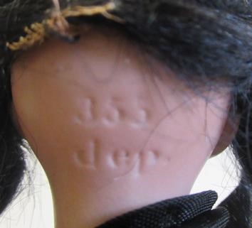 Two bisque socket head dolls comprising a 7 1/2" doll with blue glass sleeping eyes Image