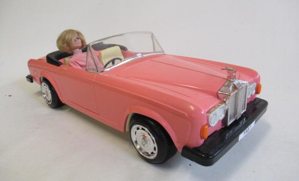 A large pink Rolls Royce with FAB1 on number plate and Lady Penelope type doll Image