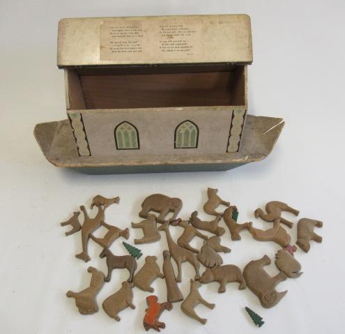 A wooden Noah's Ark with opening roof containing carved wood animals Image