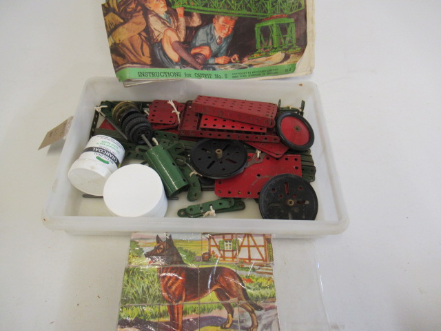 A small quantity of playworn red and green Meccano and a small wooden block puzzle (Est. plus 21% Image