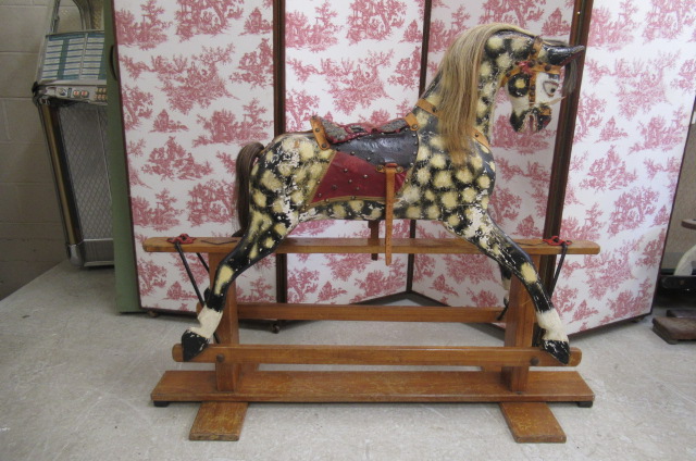 A carved wood rocking horse in dappled grey Image