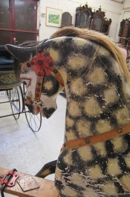 A carved wood rocking horse in dappled grey Image