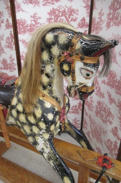 A carved wood rocking horse in dappled grey Image