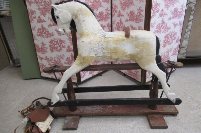 A carved wood rocking horse in white Image