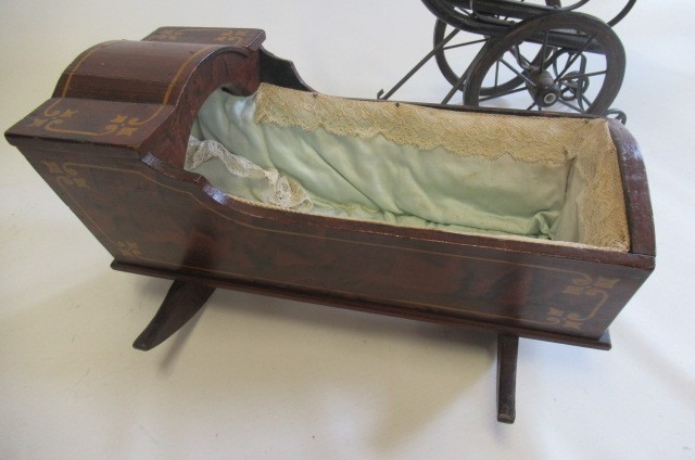 A Victorian style dolls pushchair Image