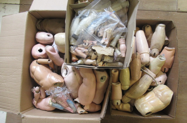 Three boxes of doll spares Image