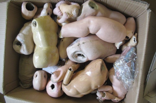 Three boxes of doll spares Image