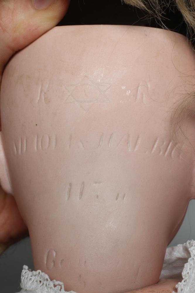 A Kammer & Reinhardt bisque socket head flirty doll Image