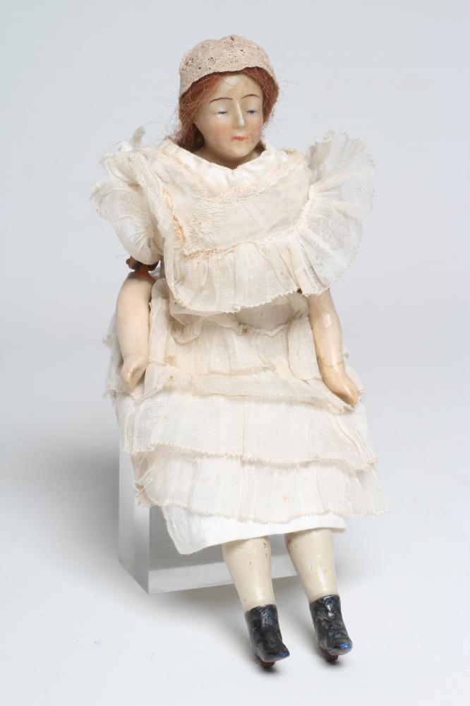 A Victorian wax shoulder head doll Image