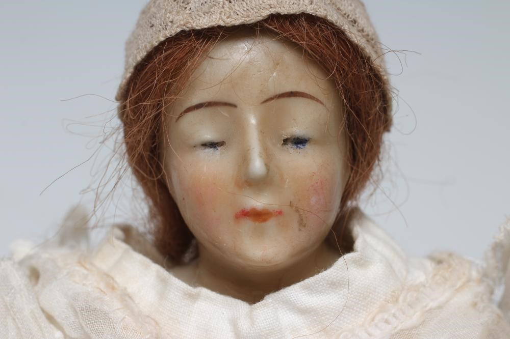 A Victorian wax shoulder head doll Image