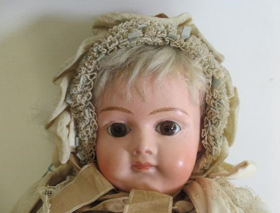An early composition shoulder head doll Image