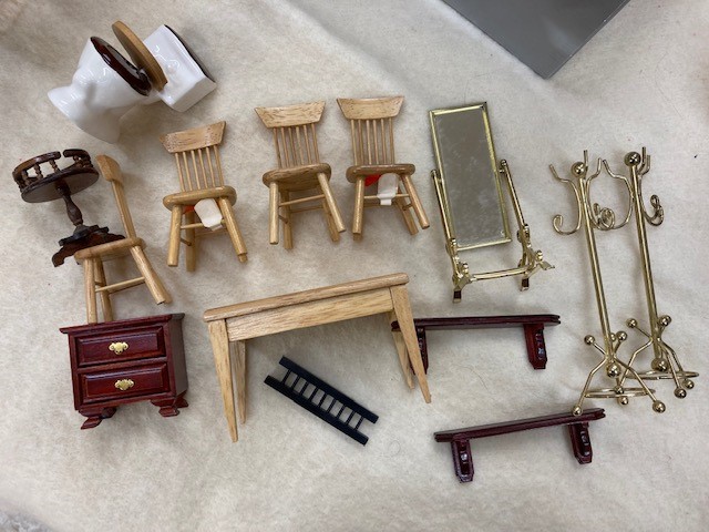 A box of doll's house furniture Image