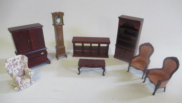A box of doll's house dolls and furniture Image