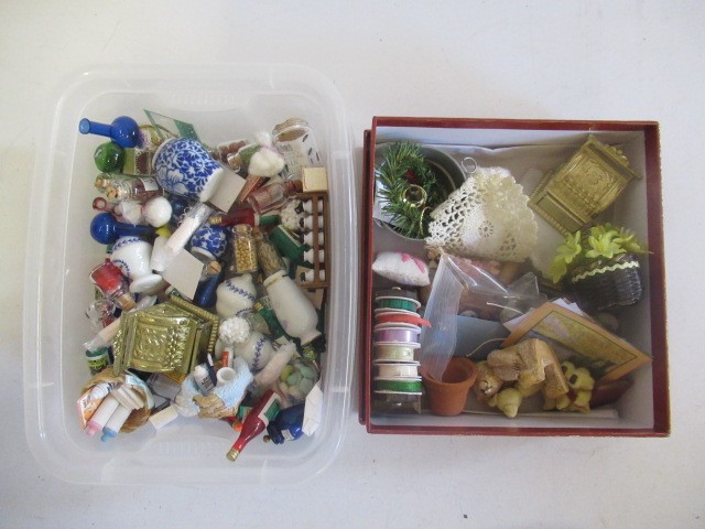 A box of doll's house dolls and furniture Image