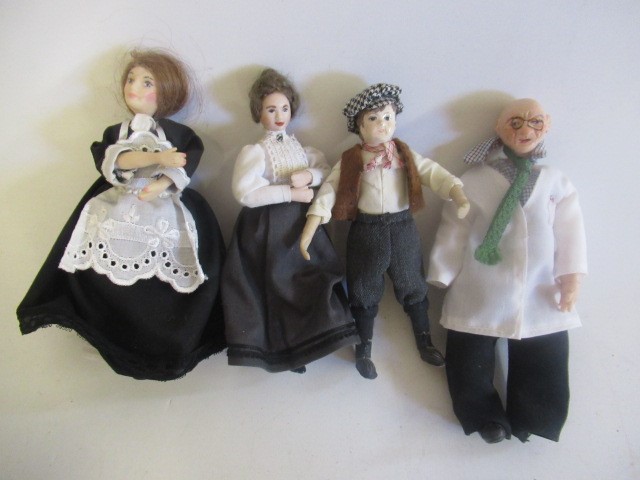 A box of doll's house dolls and furniture Image