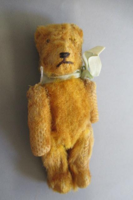 A miniature straw filled teddy Image