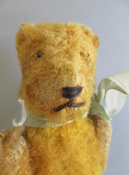 A miniature straw filled teddy Image