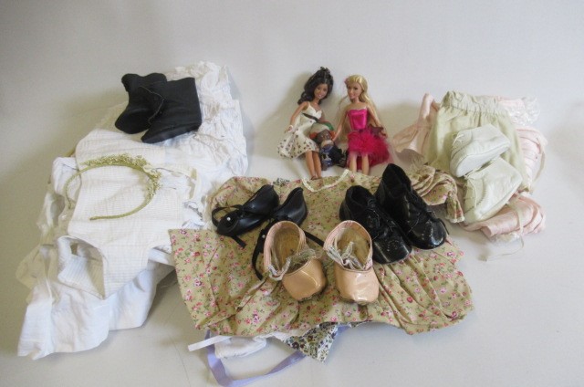 A box of dolls clothing and shoes Image