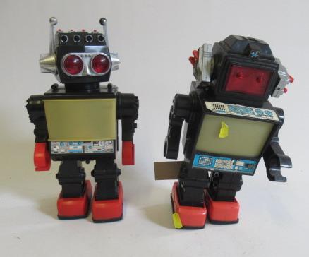 Two plastic battery operated walking robots marked Made in China Image