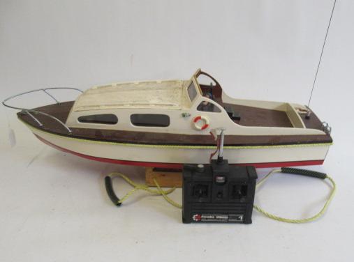 A battery powered wooden cabin cruiser with futaba two channel radio control unit Image