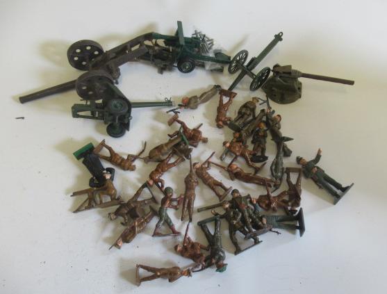 WWII lead soldiers and others in WWII dress and six field guns Image