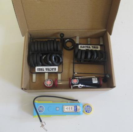 Two scale petrol pumps and two tyre stands Image