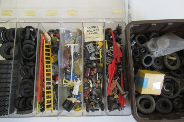 A large quantity of model car tyres and spare parts including figures Image