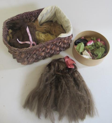 Eight spare doll wigs and hair flowers Image