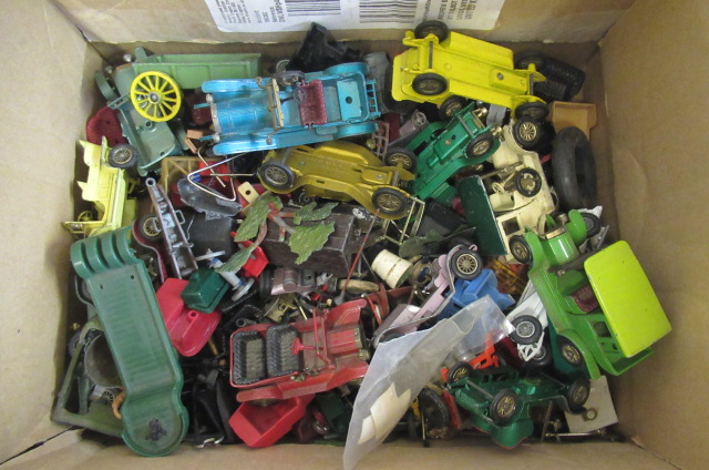 A box of spare part and damaged diecast vehicles Image