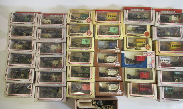 Thirty six Lledo Days Gone horse drawn vehicles including delivery wagons Image