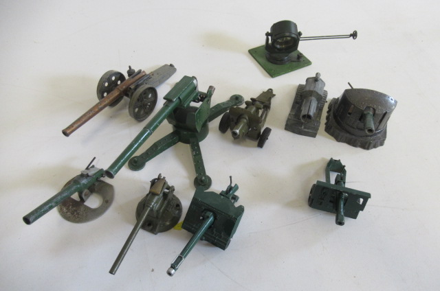 Nine field guns by various makers and an Astra Search Light on wooden base Image