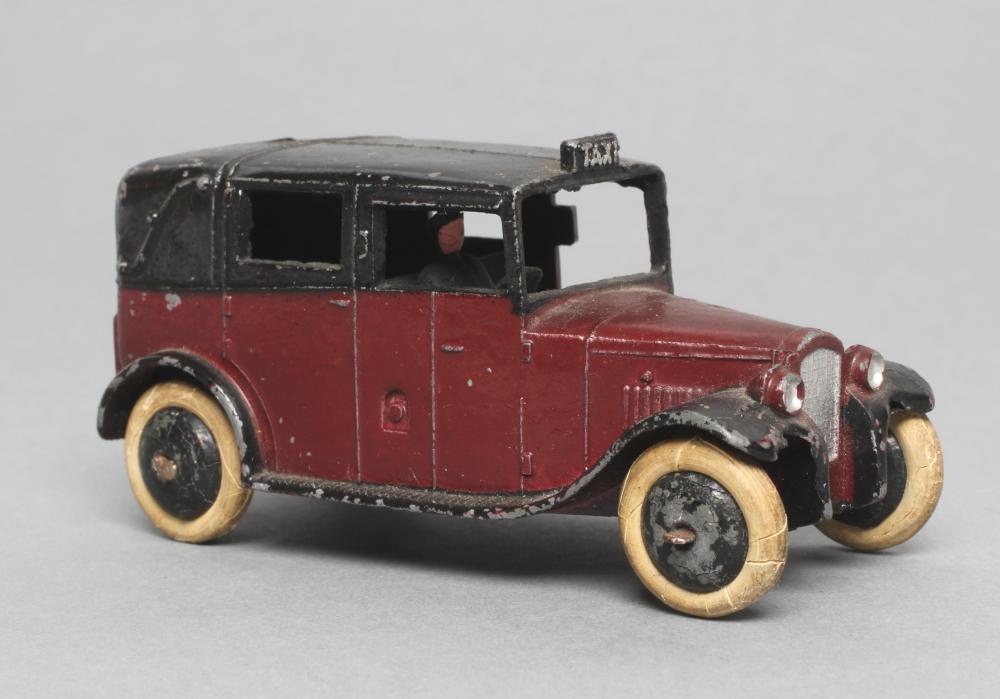 Dinky taxi with driver finished in maroon Image
