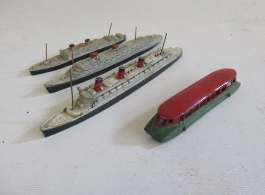 Dinky G.W.R. railcar in red/green and three Dinky passenger ships Image