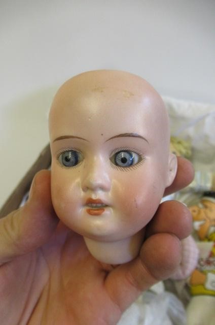 A collection of dolls and soft toys Image