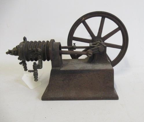A small hot air engine flywheel and cylinder on cast base Image