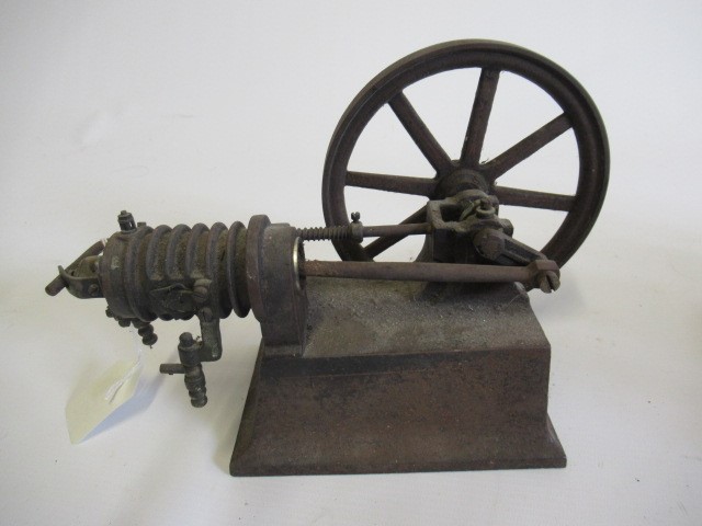 A small hot air engine flywheel and cylinder on cast base Image