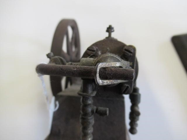 A small hot air engine flywheel and cylinder on cast base Image