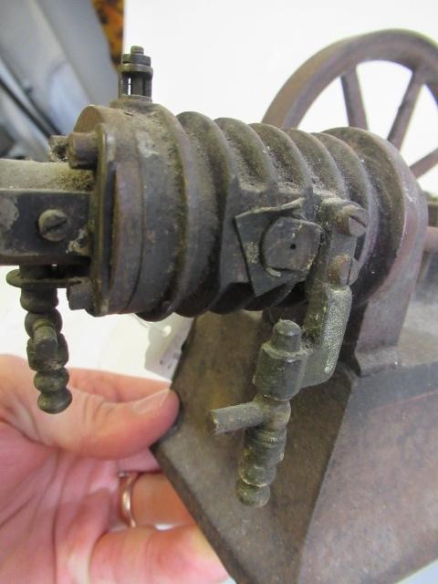 A small hot air engine flywheel and cylinder on cast base Image
