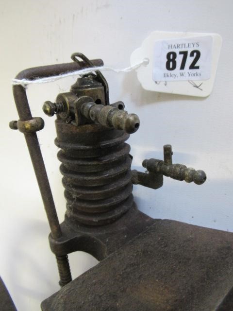 A small hot air engine flywheel and cylinder on cast base Image