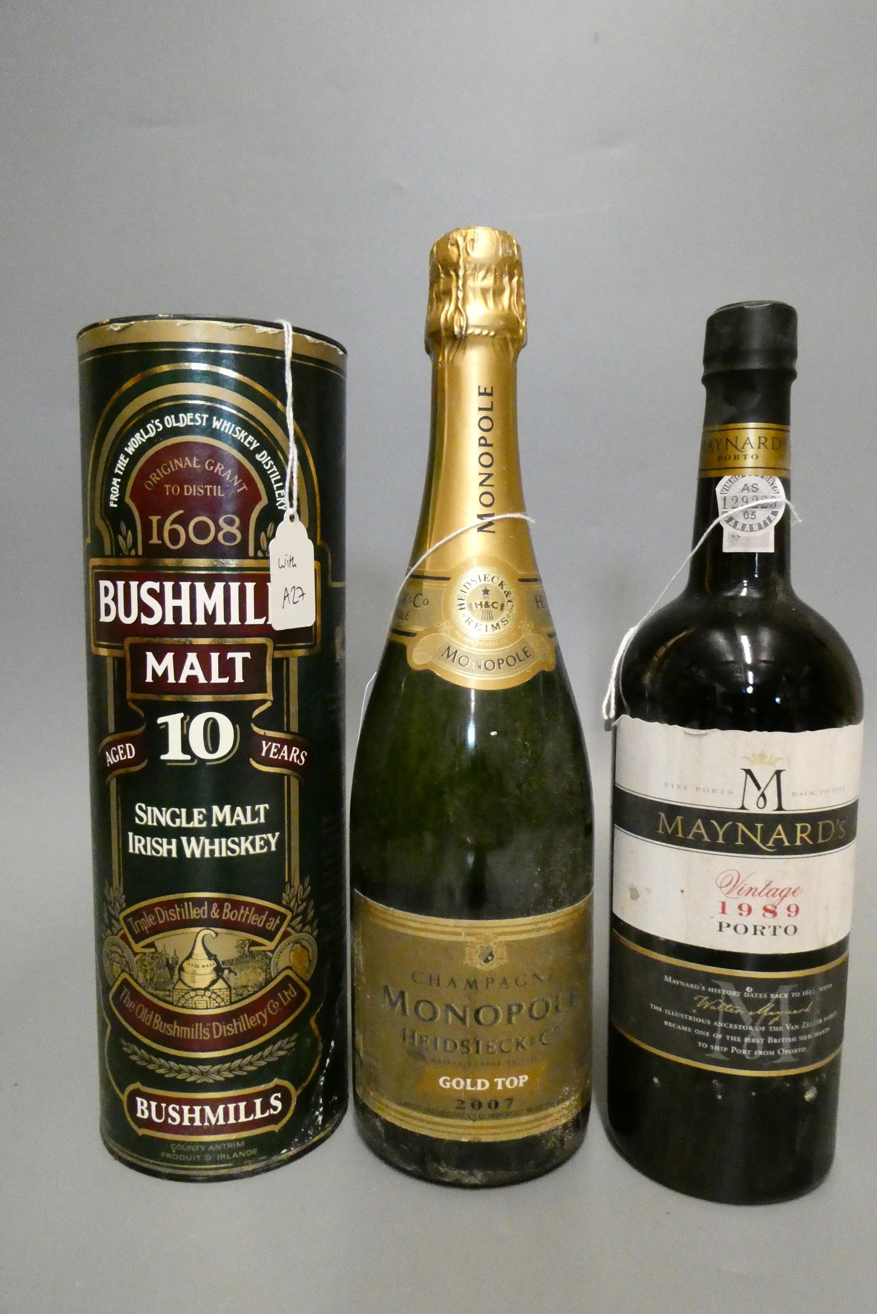 Three mixed bottles, comprising a tubed Bushmill's 10yr old Irish whiskey, a Monopole Gold Top 2007 Image