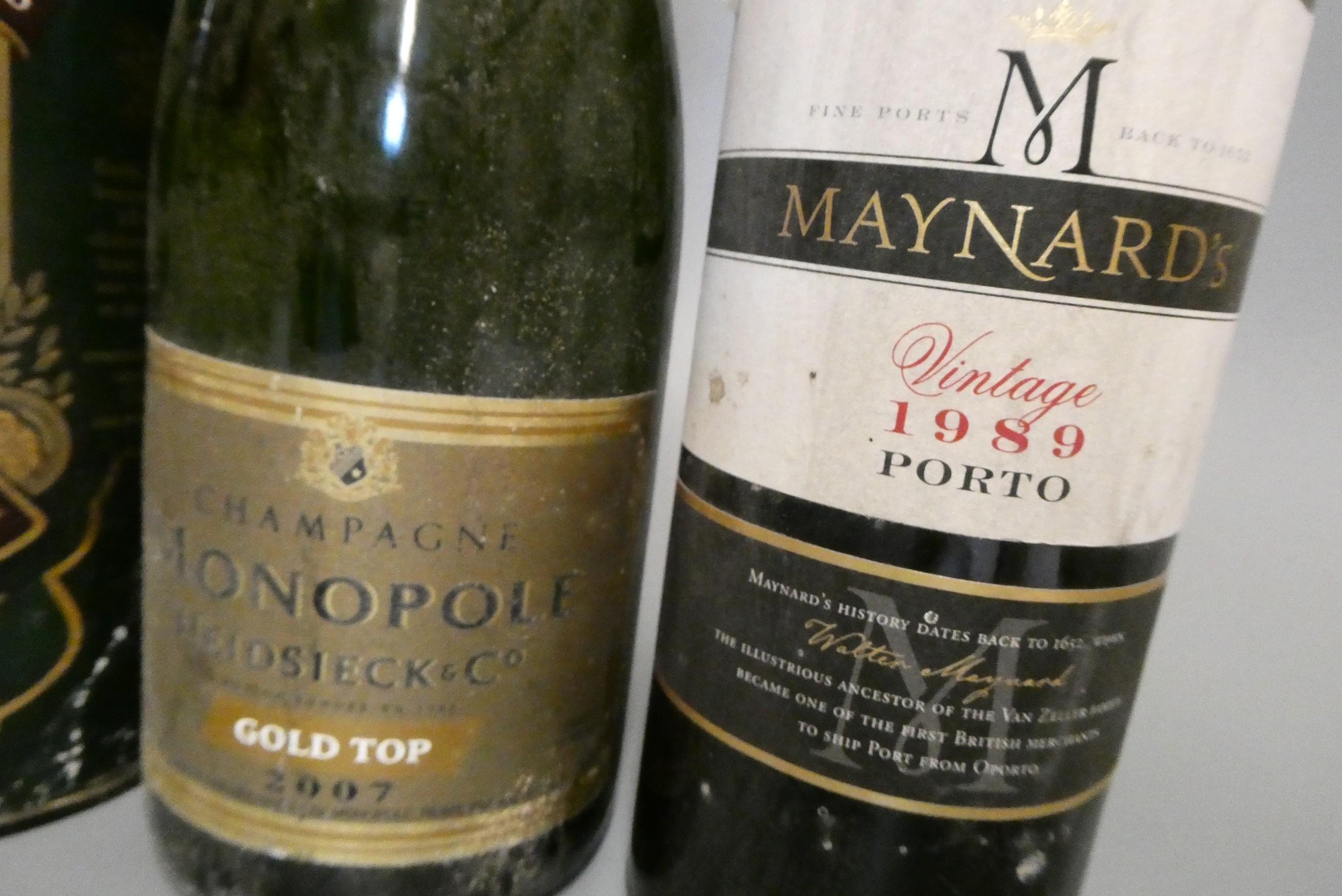 Three mixed bottles, comprising a tubed Bushmill's 10yr old Irish whiskey, a Monopole Gold Top 2007 Image