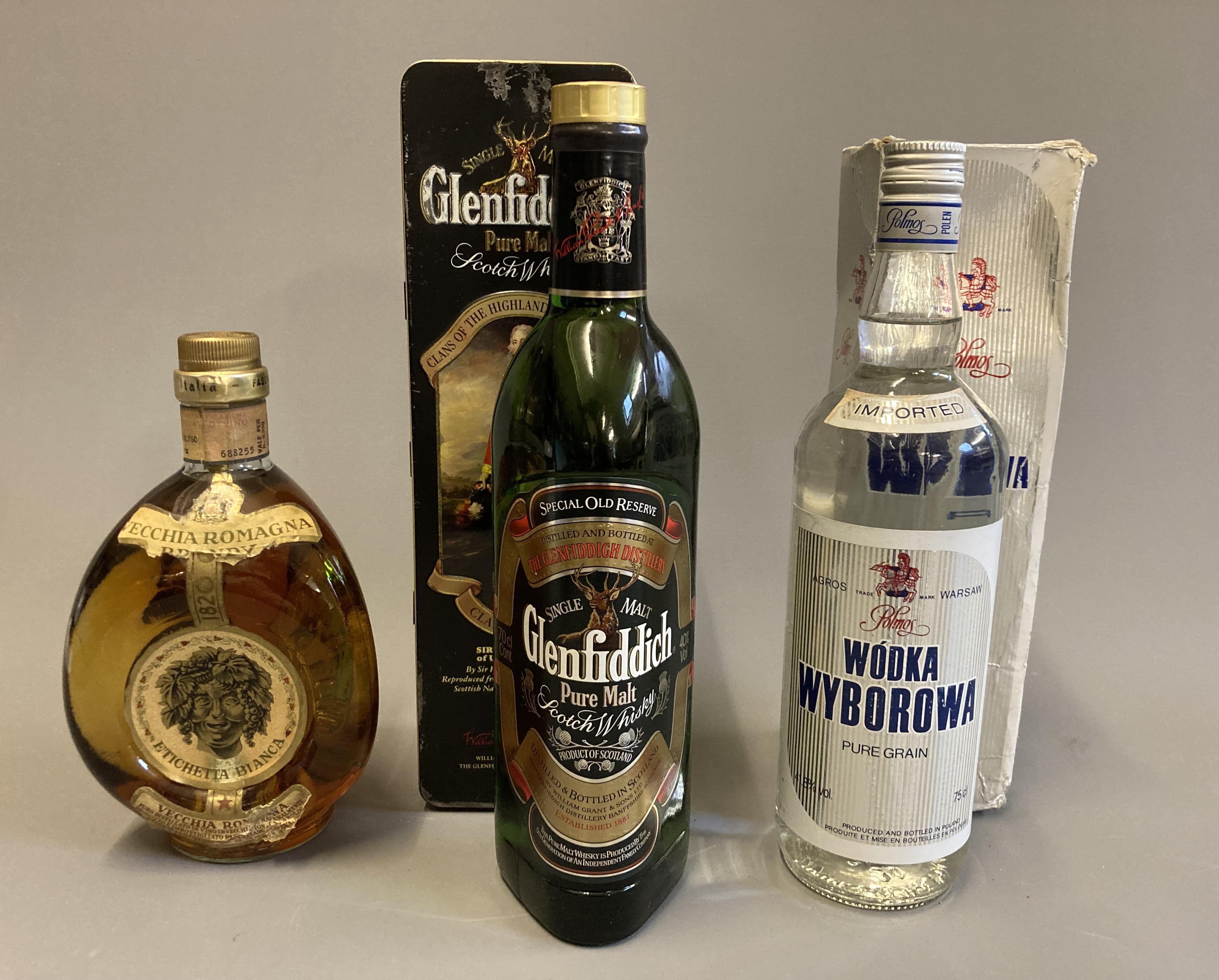 Three bottled spirits, comprising a tinned Gelnfiddich Clan Sinclair pure malt, a vintage Vecchia Image