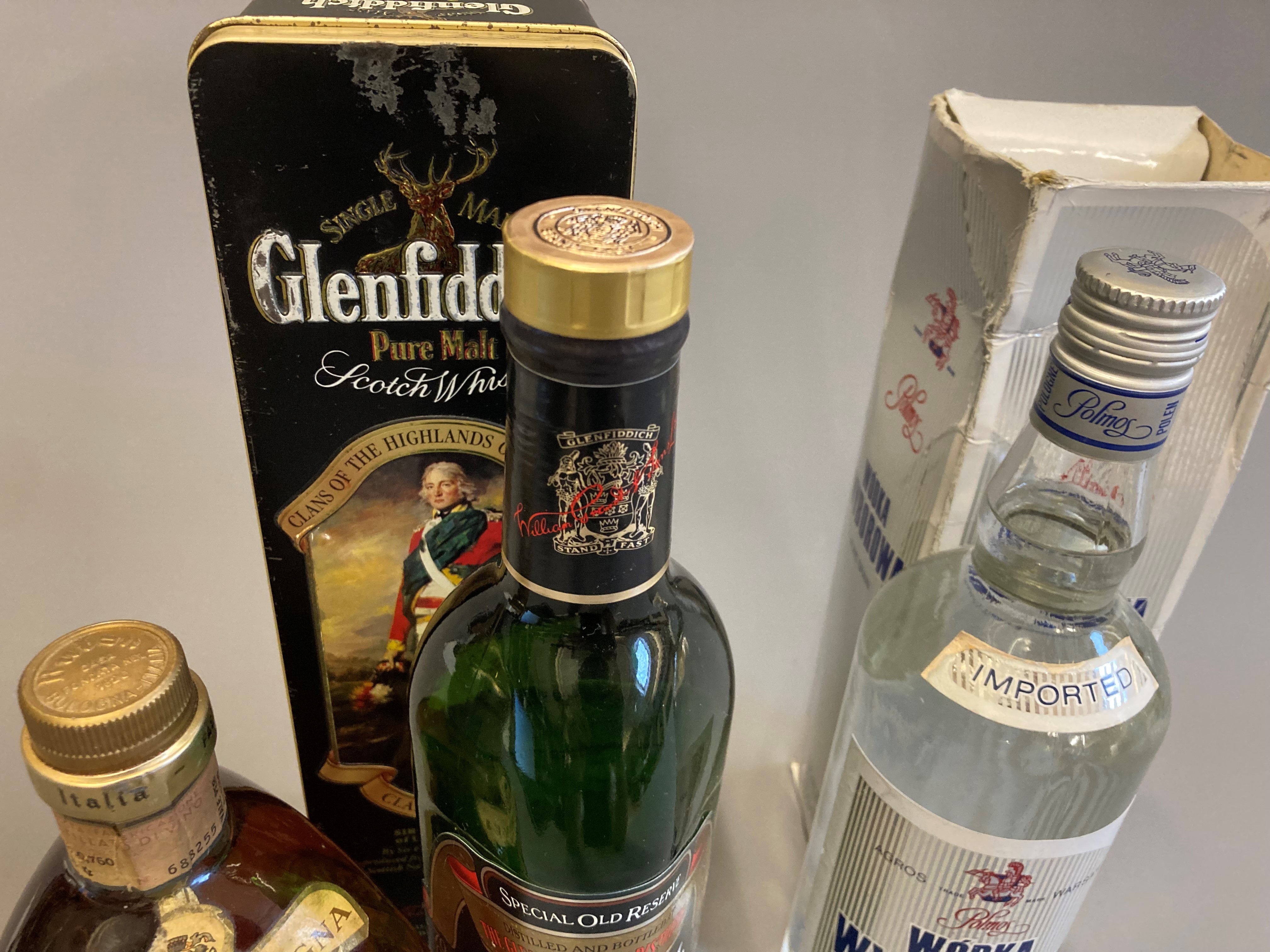 Three bottled spirits, comprising a tinned Gelnfiddich Clan Sinclair pure malt, a vintage Vecchia Image