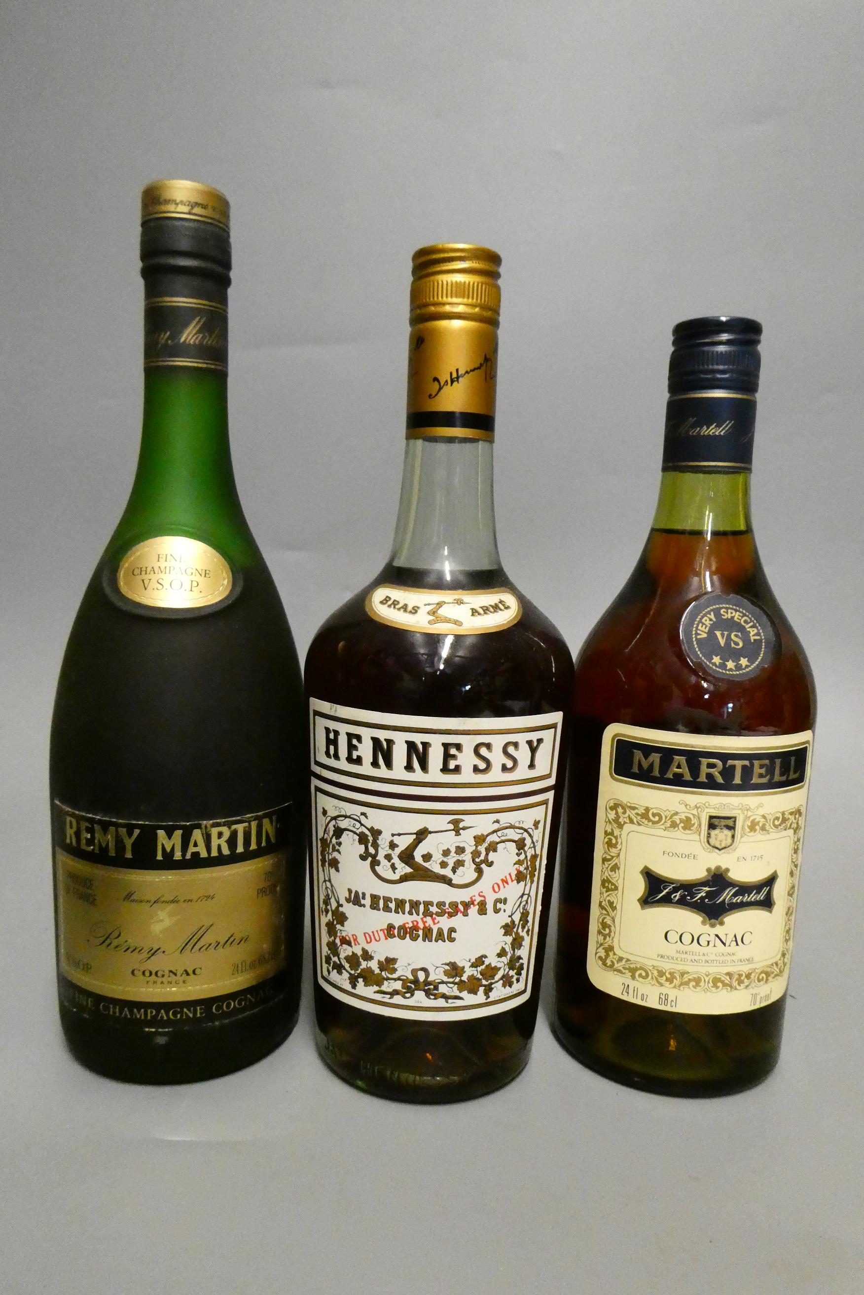 Three bottles of Cognac, comprising a Hennessy Bras Arme, a 68cl Martell VS and a 68.2cl Remy Martin Image