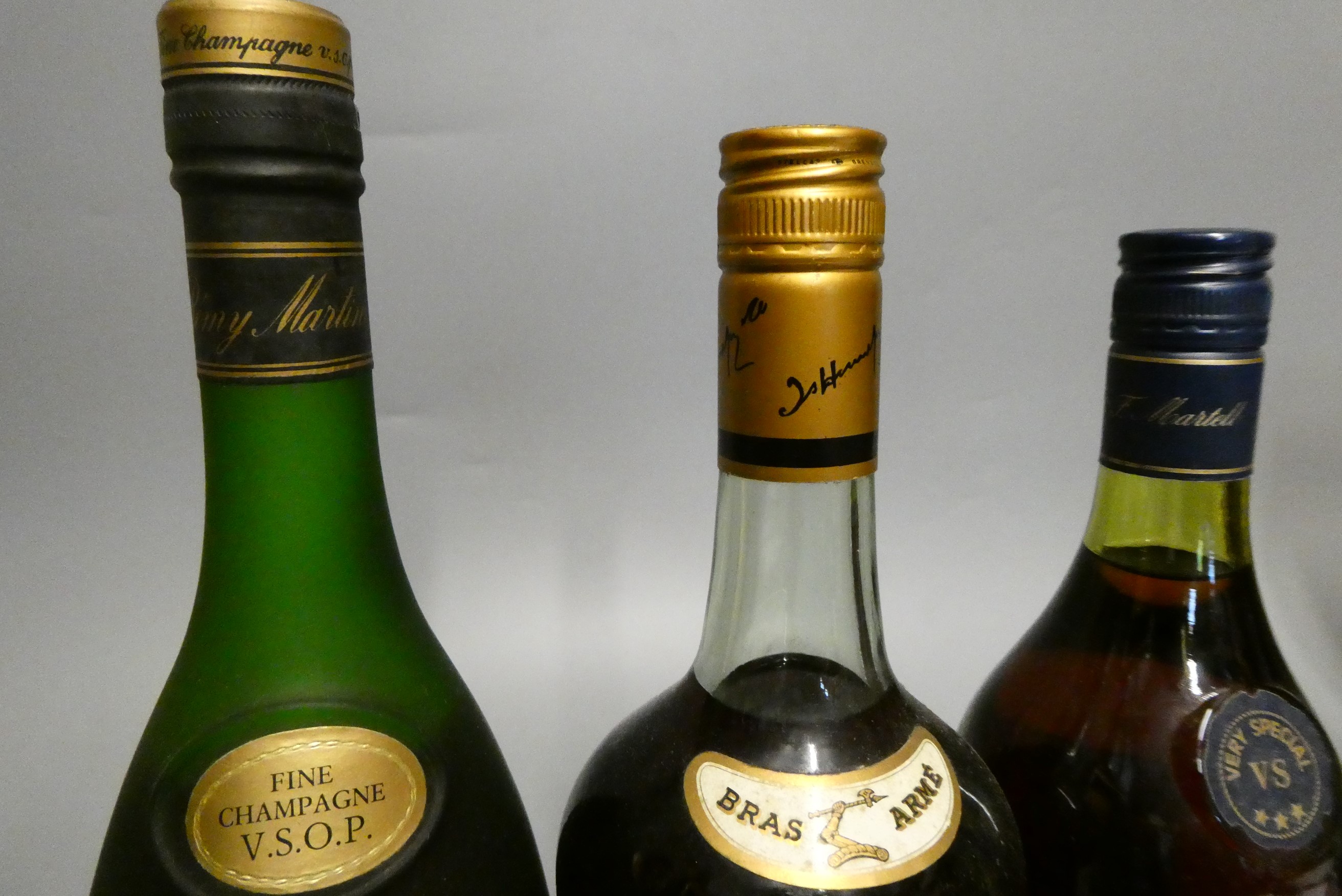 Three bottles of Cognac, comprising a Hennessy Bras Arme, a 68cl Martell VS and a 68.2cl Remy Martin Image